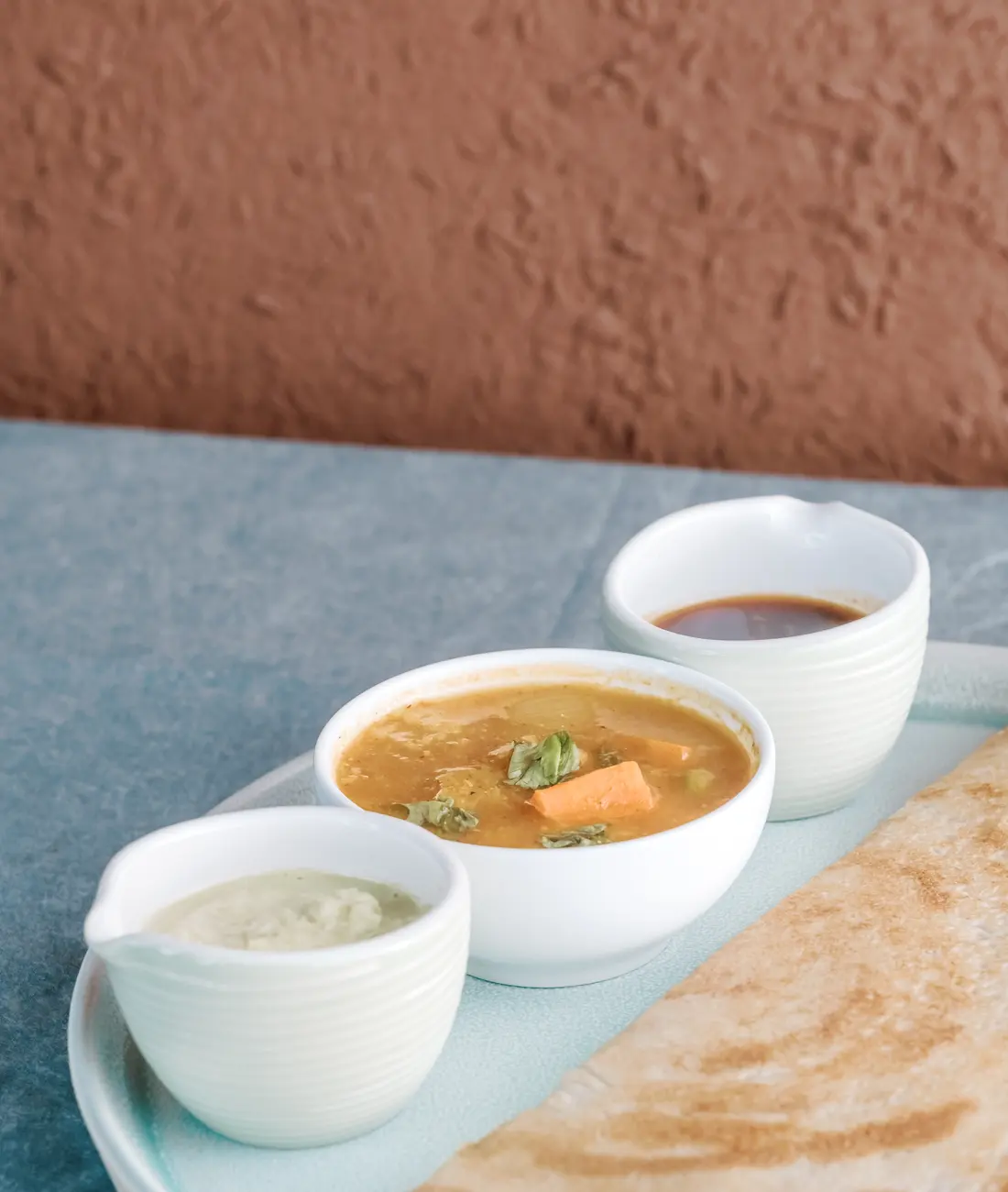 Masala dosa served with chutneys and sambar